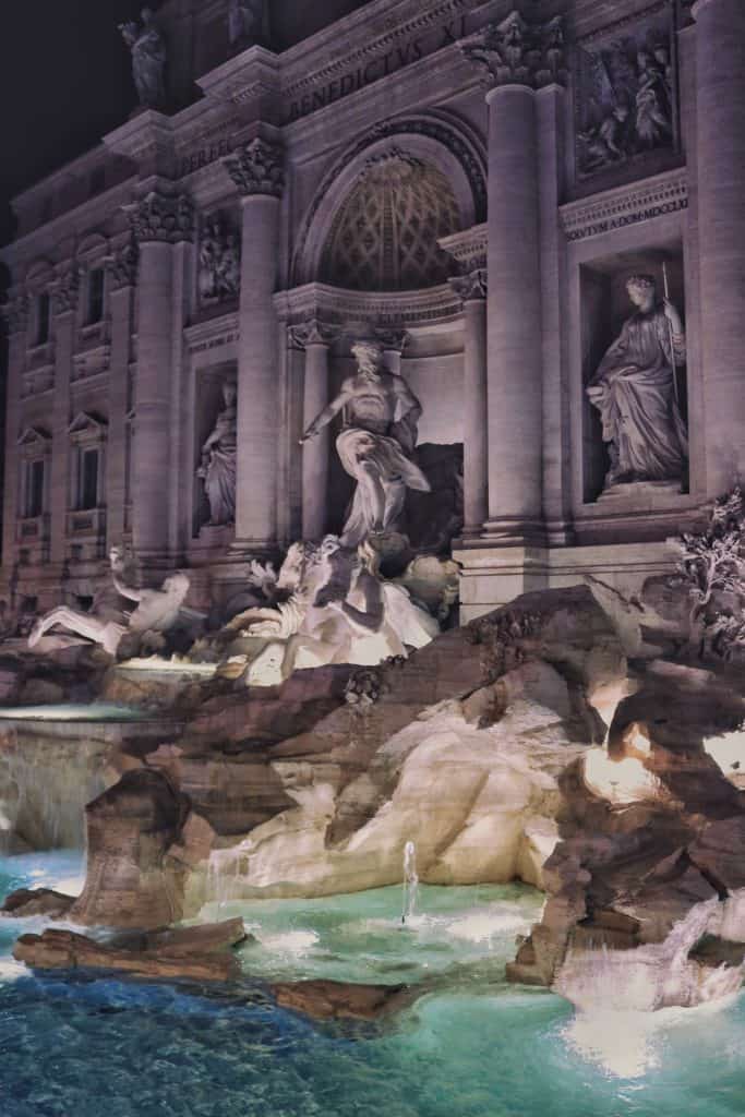 Trevi fountain at night with lit statues