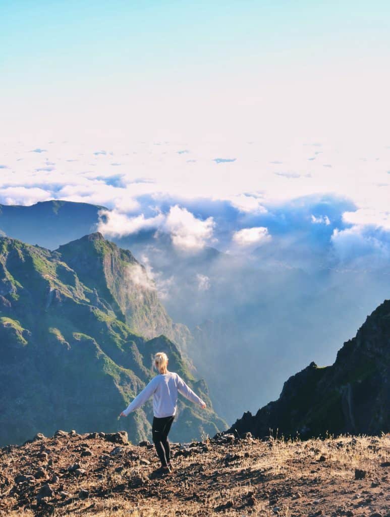 Girl dancing in front of a huge mountain 