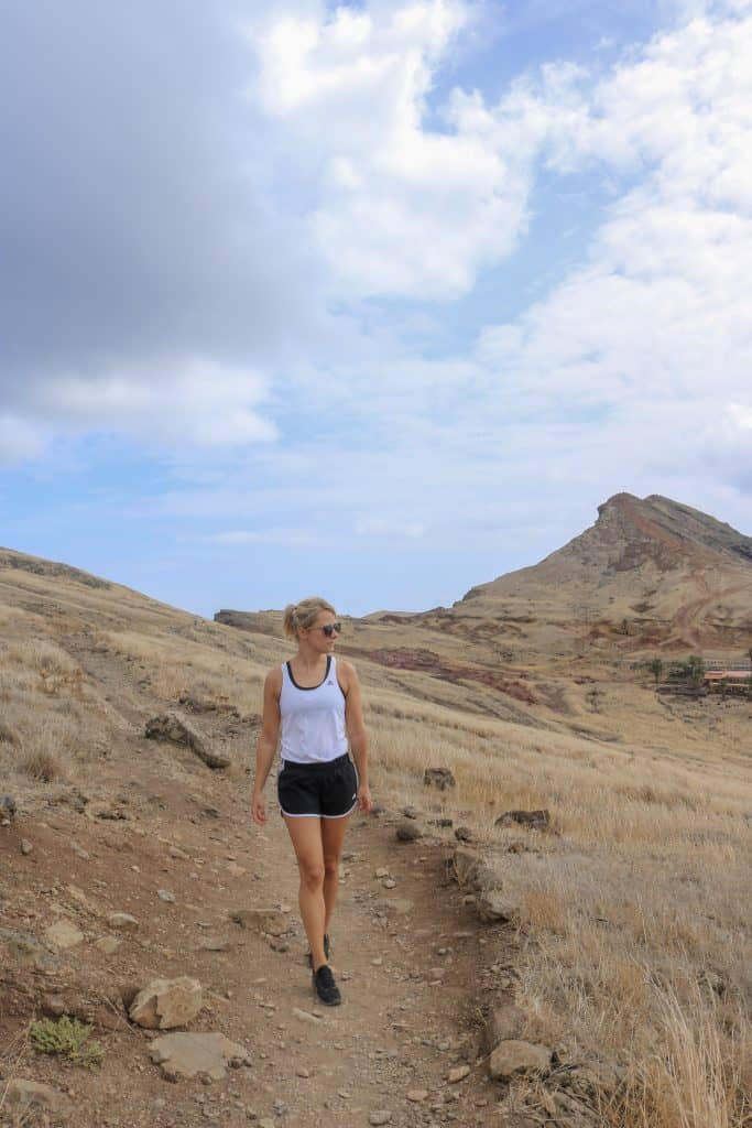 Girl with a white top and black shorts hiking in Madeira Ponta da sao lourenco