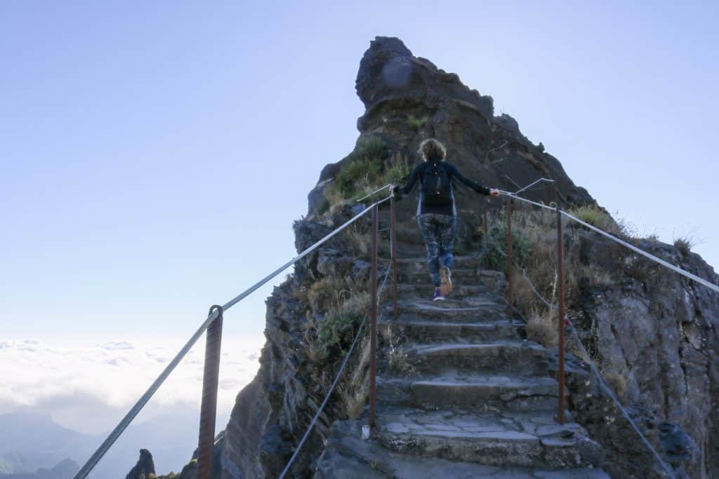 Girl climbing the steps of a mountain path Madeira