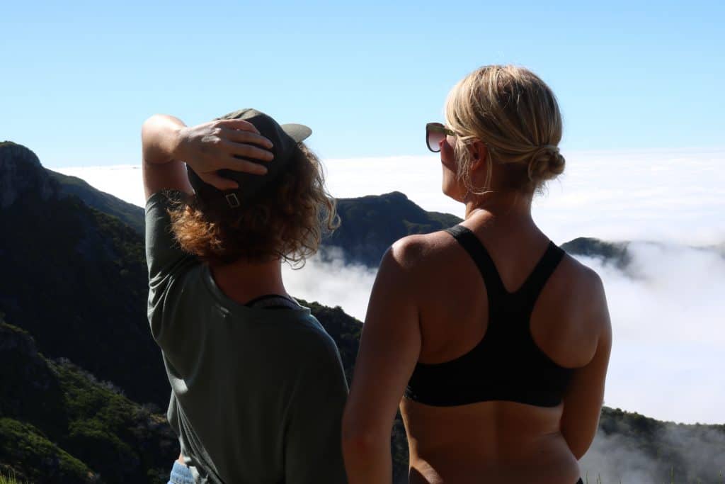 Two girls overlooking a mountain and a sea of clouds