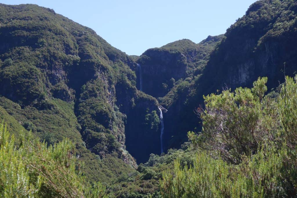 Huge green mountain range with a waterfall in the middle
