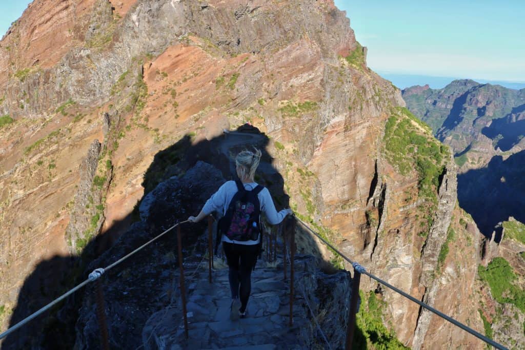 Girl descending stairs on a hiking trail in the mountains