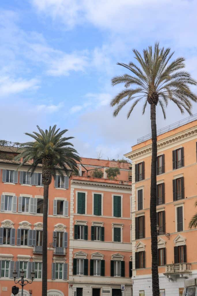 Pink and orange houses with two big palmtrees in front of them