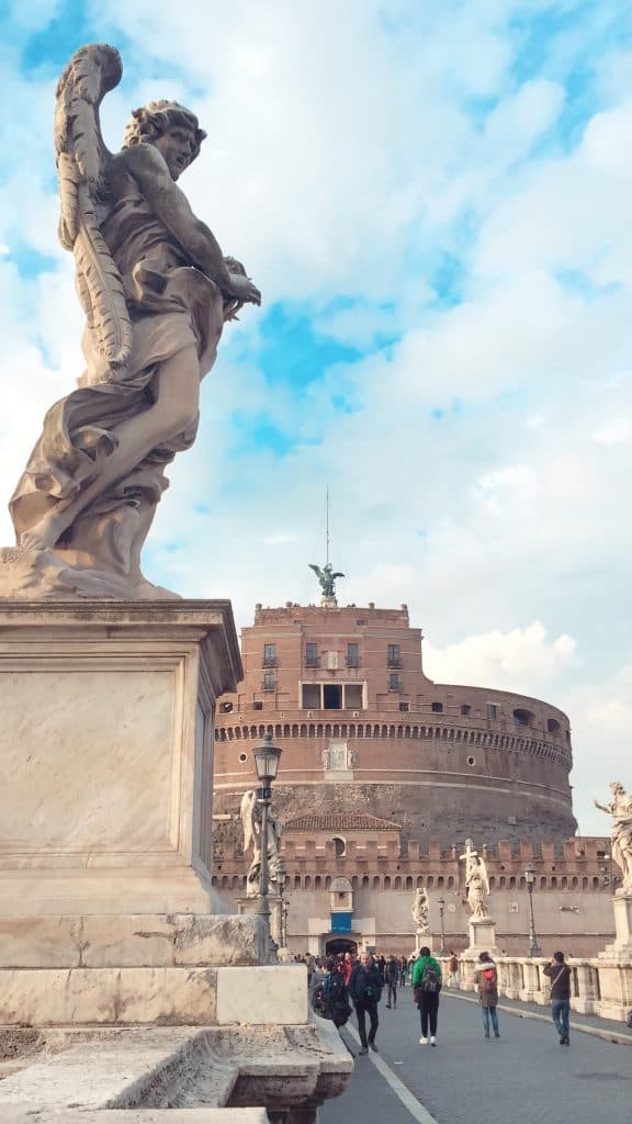 Statue of an angel with the bridge behind it