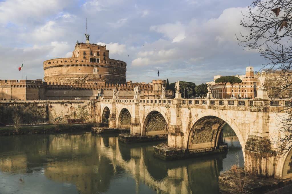 Bridge with angel statues and a reflection in the water 