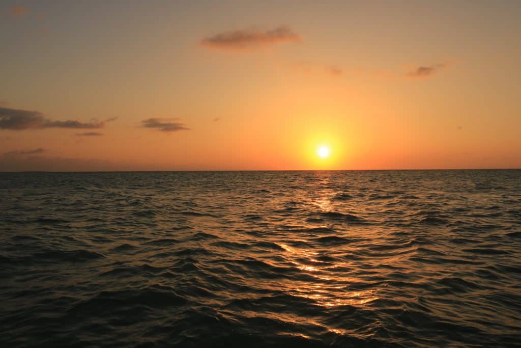 Sunset over the ocean with an orange sky