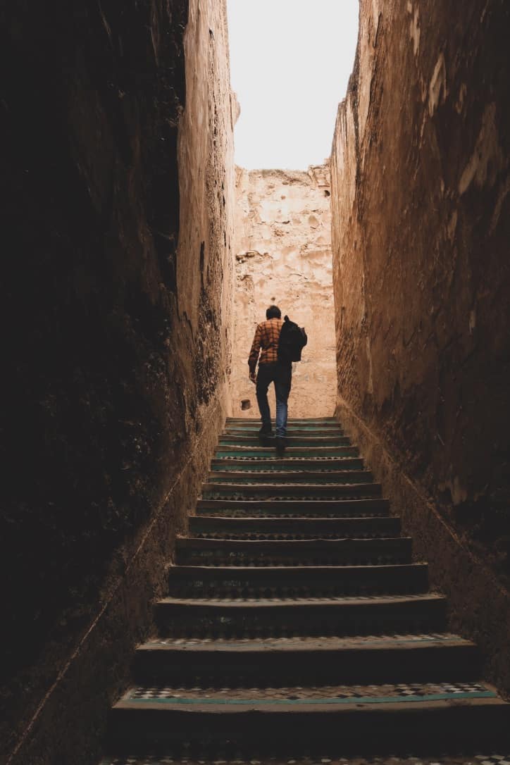 Guy with backpack going up stairs in Marrakech