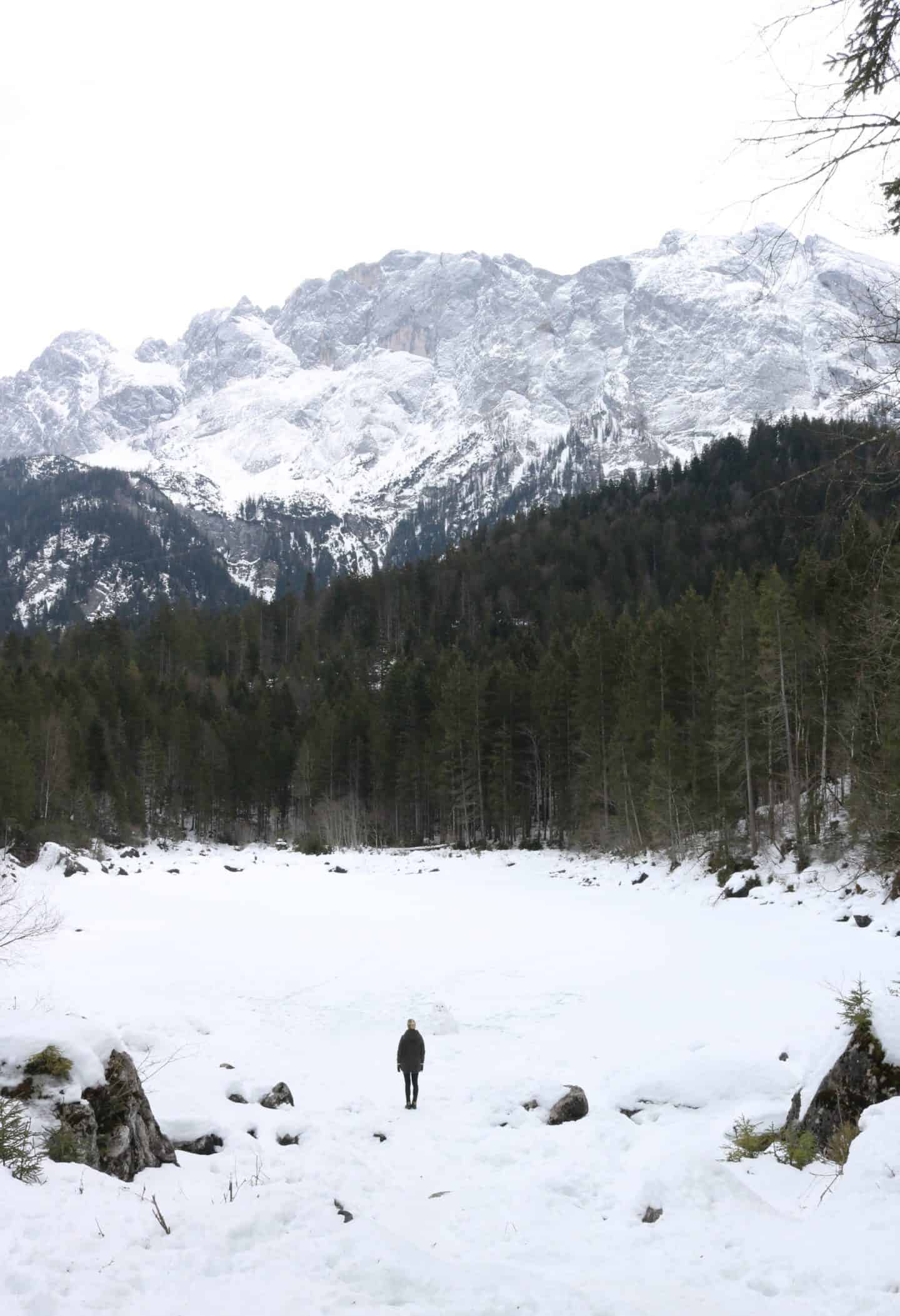 Girl standing in front of a snowy mountain