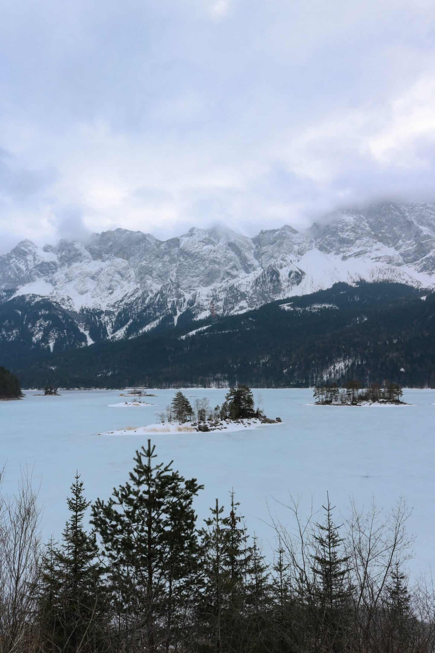 Frozen lake with a huge mountain behind it