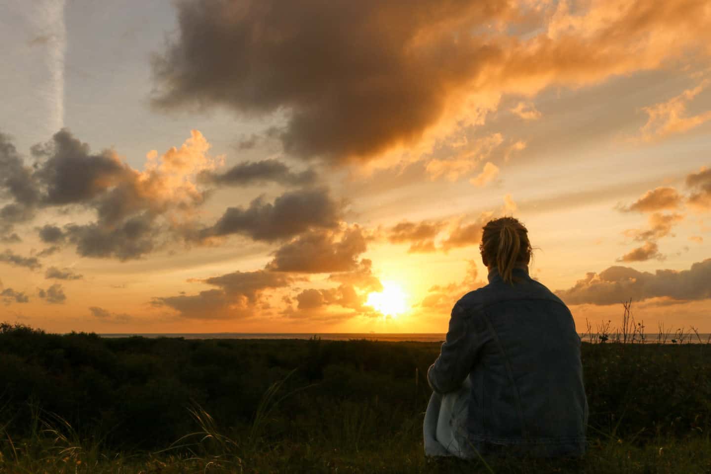 Girl watching the sunset on Schiermonnikoog